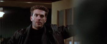 Movie still from “The Long Kiss Goodnight” (1996), directed by Renny Harlin – A person wearing a leather jacket; Close Up shot, Low angle