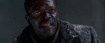 Movie still from “The Long Kiss Goodnight” (1996), directed by Renny Harlin – A man with blood all over his face; Close Up shot, Low angle