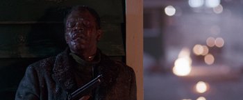 Movie still from “The Long Kiss Goodnight” (1996), directed by Renny Harlin – A man holding a gun while wearing a jacket; Close Up shot, Low angle