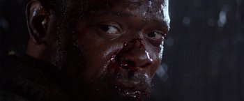 Movie still from “The Long Kiss Goodnight” (1996), directed by Renny Harlin – A man's face covered in blood; Extreme Close Up shot, Low angle