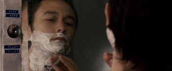 Movie still from “The Lookout” (2007), directed by Scott Frank – A man shaving his face in the mirror; Close Up shot, Over the shoulder angle