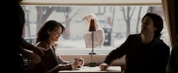 Movie still from “The Lookout” (2007), directed by Scott Frank – Two people sitting at a table in front of a window; Medium shot, Over the shoulder angle