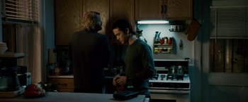 Movie still from “The Lookout” (2007), directed by Scott Frank – Two men standing in a kitchen next to each other; Medium shot, Over the shoulder angle