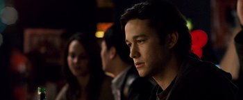 Movie still from “The Lookout” (2007), directed by Scott Frank – A person sitting in front of other people; Close Up shot, Over the shoulder angle