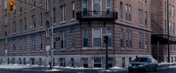 Movie still from “The Lookout” (2007), directed by Scott Frank – A street sign on the side of a building; Extreme Wide shot, High angle