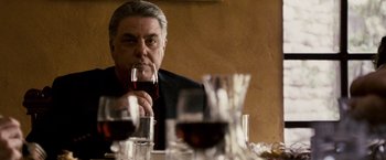 Movie still from “The Lookout” (2007), directed by Scott Frank – A man sitting at a table with a glass of red wine; Close Up shot, Over the shoulder angle