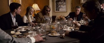 Movie still from “The Lookout” (2007), directed by Scott Frank – A group of people sitting around a table with glasses of wine; Medium shot, Over the shoulder angle