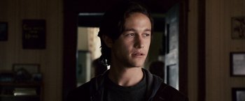 Movie still from “The Lookout” (2007), directed by Scott Frank – A man with long dark hair wearing a black jacket; Close Up shot, Over the shoulder angle