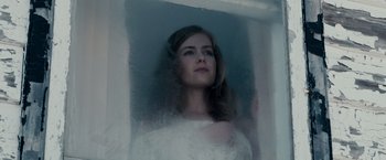 Movie still from “The Lookout” (2007), directed by Scott Frank – A beautiful young lady standing in front of a window; Close Up shot, Low angle