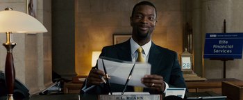 Movie still from “The Lookout” (2007), directed by Scott Frank – A man in a suit and tie holding papers and a pen; Close Up shot, Over the shoulder angle