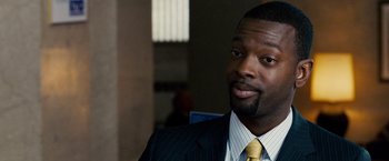 Movie still from “The Lookout” (2007), directed by Scott Frank – A person wearing a suit and tie; Close Up shot, Over the shoulder angle