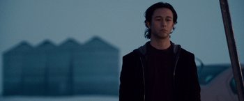 Movie still from “The Lookout” (2007), directed by Scott Frank – A man standing in front of a building at dusk; Close Up shot, Low angle
