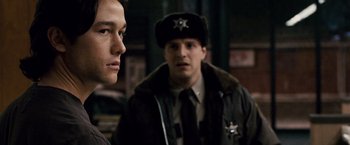 Movie still from “The Lookout” (2007), directed by Scott Frank – Two police officers are standing next to each other; Close Up shot, Over the shoulder angle