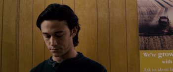 Movie still from “The Lookout” (2007), directed by Scott Frank – A man with long black hair is looking down; Close Up shot, Over the shoulder angle