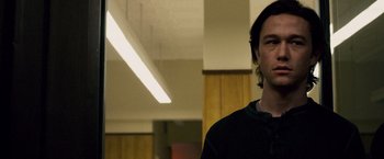 Movie still from “The Lookout” (2007), directed by Scott Frank – A man standing in a room with a light fixture; Close Up shot, Low angle