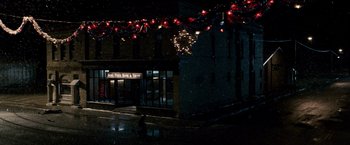 Movie still from “The Lookout” (2007), directed by Scott Frank – A building that has lights hanging over it; Extreme Wide shot, High angle
