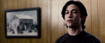 Movie still from “The Lookout” (2007), directed by Scott Frank – A young man standing in front of a painting; Close Up shot, Over the shoulder angle