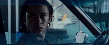 Movie still from “The Lookout” (2007), directed by Scott Frank – A young man is sitting in the driver's seat of a car; Close Up shot, Over the shoulder angle