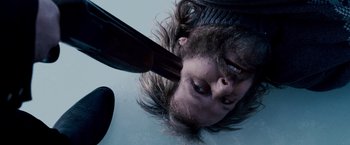 Movie still from “The Lookout” (2007), directed by Scott Frank – A man with long hair is holding a gun; Close Up shot, Overhead angle