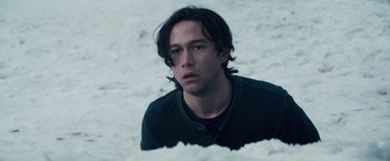 Movie still from “The Lookout” (2007), directed by Scott Frank – A young man sitting on the ground in the snow; Close Up shot, High angle