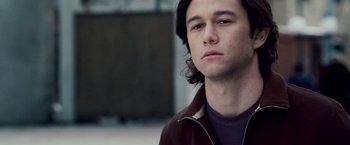 Movie still from “The Lookout” (2007), directed by Scott Frank – A man with long hair and a brown jacket; Close Up shot, Over the shoulder angle