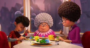 Movie still from “The Lorax” (2012), directed by Chris Renaud – Three people sitting at a table with a plate of food on it; Medium shot, Over the shoulder angle