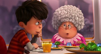 Movie still from “The Lorax” (2012), directed by Chris Renaud – A person sitting at a table with a glass of orange juice; Medium shot, Over the shoulder angle