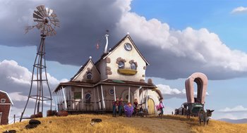 Movie still from “The Lorax” (2012), directed by Chris Renaud – A group of people standing outside of a house on a dry grass field; Extreme Wide shot, Low angle