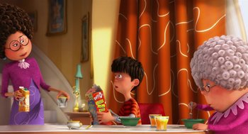 Movie still from “The Lorax” (2012), directed by Chris Renaud – A boy sitting at a table holding a box of chips; Medium shot, Over the shoulder angle
