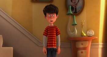 Movie still from “The Lorax” (2012), directed by Chris Renaud – A boy is standing in front of a wall; Medium shot, High angle
