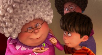 Movie still from “The Lorax” (2012), directed by Chris Renaud – An old woman is holding a cookie in her hand while a young boy and girl look on; Close Up shot, Over the shoulder angle