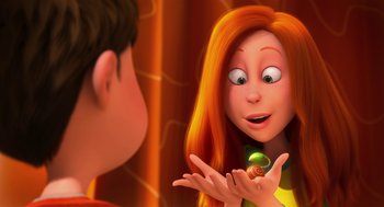Movie still from “The Lorax” (2012), directed by Chris Renaud – An animated picture of a woman holding a small object in front of a boy; Close Up shot, Over the shoulder angle
