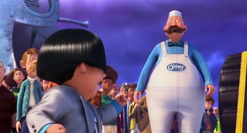 Movie still from “The Lorax” (2012), directed by Chris Renaud – A man is standing next to an animated character; Medium shot, Over the shoulder angle