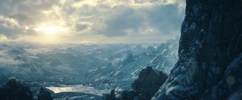 Movie still from “The Lord of the Rings: The Rings of Power” (2022), created by Patrick McKay – A view of a mountain range with snow on it's slopes; Extreme Wide shot, High angle