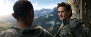 Movie still from “The Lord of the Rings: The Rings of Power” (2022), created by Patrick McKay – A man standing next to another man on top of a mountain; Close Up shot, Over the shoulder angle