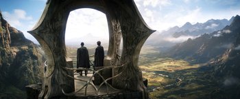 Movie still from “The Lord of the Rings: The Rings of Power” (2022), created by Patrick McKay – Two people standing on a platform looking out over a valley; Wide shot, Low angle