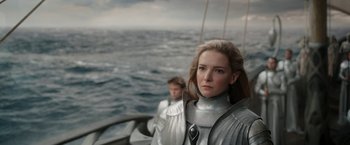 Movie still from “The Lord of the Rings: The Rings of Power” (2022), created by Patrick McKay – Two people on a boat on the water; Close Up shot, Low angle