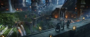 Movie still from “The Lord of the Rings: The Rings of Power” (2022), created by Patrick McKay – A group of people standing on top of a building; Extreme Wide shot, High angle