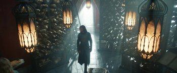 Movie still from “The Lord of the Rings: The Rings of Power” (2022), created by Patrick McKay – A man walking down a hall way in a building; Wide shot, Low angle