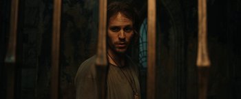 Movie still from “The Lord of the Rings: The Rings of Power” (2022), created by Patrick McKay – A man with long hair standing in front of a window; Close Up shot, Low angle