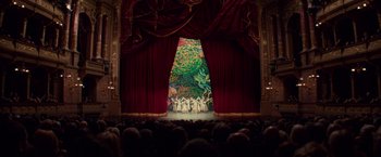 Movie still from “Red Sparrow” (2018), directed by Francis Lawrence – A stage with a curtain open and people watching; Extreme Wide shot, High angle