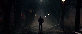 Movie still from “Red Sparrow” (2018), directed by Francis Lawrence – A man standing in the middle of a dark street; Wide shot, Low angle