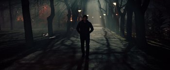 Movie still from “Red Sparrow” (2018), directed by Francis Lawrence – A man standing in the middle of a street; Wide shot, Low angle