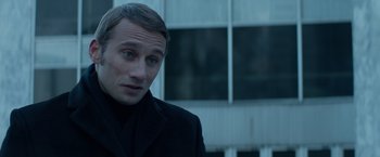 Movie still from “Red Sparrow” (2018), directed by Francis Lawrence – A person wearing a suit and tie; Close Up shot, Over the shoulder angle