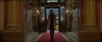 Movie still from “Red Sparrow” (2018), directed by Francis Lawrence – A woman is walking down a red carpet in front of a building; Wide shot, Low angle
