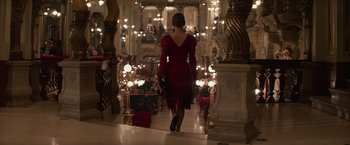 Movie still from “Red Sparrow” (2018), directed by Francis Lawrence – A woman in a red dress walking down a hall way; Wide shot, Low angle