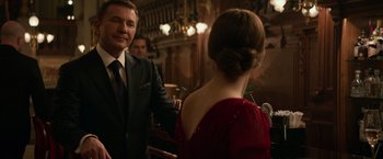 Movie still from “Red Sparrow” (2018), directed by Francis Lawrence – A man and a woman are shaking hands in front of a bar; Medium shot, Over the shoulder angle