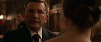 Movie still from “Red Sparrow” (2018), directed by Francis Lawrence – A person wearing a suit and tie; Close Up shot, Over the shoulder angle