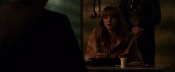 Movie still from “Red Sparrow” (2018), directed by Francis Lawrence – A woman sitting in front of a mirror in a room; Medium shot, Over the shoulder angle