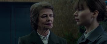 Movie still from “Red Sparrow” (2018), directed by Francis Lawrence – An older woman wearing a suit and a tie; Close Up shot, Over the shoulder angle